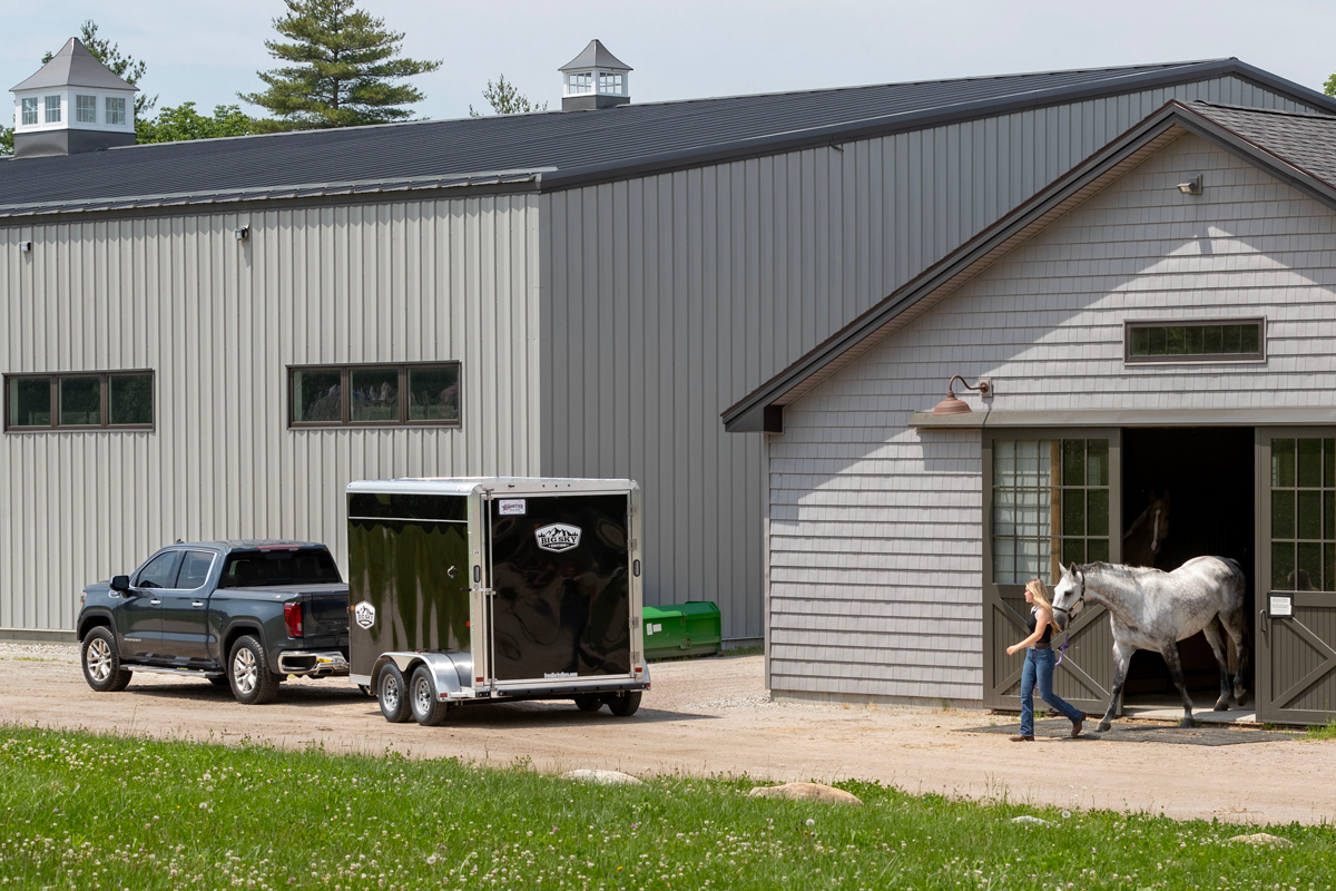 Black Truck Parked With Black Colt Big Sky Combo Slant Load Series In Front Of Barn